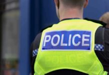 Chaos Erupts When Police Pull Back Police officer wearing a high-visibility vest