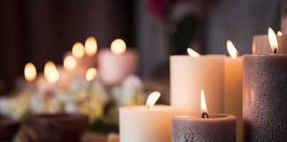 lit pillar candles on a woven mat