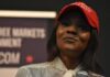 woman in a red cap holding a microphone