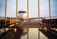 Border Chaos Triggers U.S. Travel Warning Airplane seen through terminal windows with empty gate seating