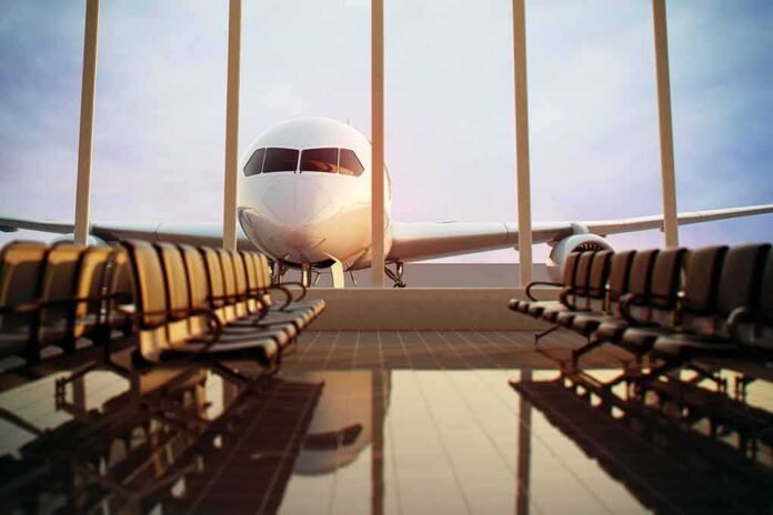 Airplane seen through terminal windows with empty gate seating