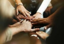 Google Kingpin Jumps—$10B Bet on Robo-Science Group hands stacked in a teamwork gesture