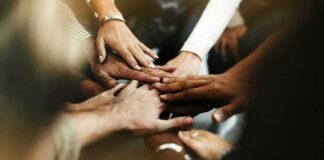 Group hands stacked in a teamwork gesture