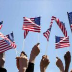 Ratings Earthquake: IndyCar Stuns FOX Hands waving American flags against a blue sky