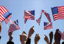 Ratings Earthquake: IndyCar Stuns FOX Hands waving American flags against a blue sky