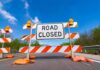 Wildlife Bridge Triggers SoCal Commute Meltdown Road closed barricade with orange sandbags on a sunny day
