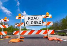 Wildlife Bridge Triggers SoCal Commute Meltdown Road closed barricade with orange sandbags on a sunny day