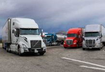 Highway Crackdown Slams California Funding Semi trucks parked at a rest area under cloudy sky