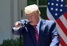 speaker at podium pointing during outdoor press event