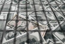 $100M Mirage: Bank Duped By Paperwork? pile of us dollar bills with a ten-dollar note on top