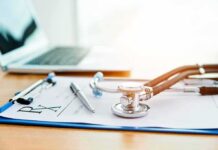 Rogan Slams America’s Medical Debt Trap Stethoscope on a prescription form beside a pen and laptop