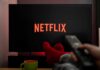 Netflix Paywall Ambushes GTA VI Hype TV screen with Netflix logo and person holding remote