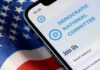 Abolish ICE Push Explodes Inside DNC Smartphone showing a political committee webpage on an American flag