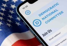 Smartphone showing a political committee webpage on an American flag