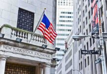 Ellison Plunges—Oracle Carnage Stuns Wall Street Facade of the New York Stock Exchange with an American flag and Wall Street sign
