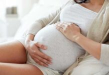 Birth Tourism Crackdown Shocks Visa Holders pregnant woman resting with hands on belly