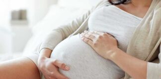 pregnant woman resting with hands on belly