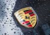 Porsche crest on wet car hood