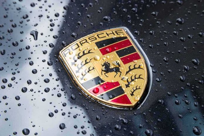 shutterstock_719355487 Porsche crest on wet car hood
