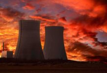 Nuclear Lifeline CUT — Five Days of Panic Silhouette of cooling towers against a vibrant sunset sky
