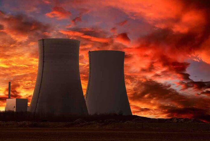 shutterstock_73078270 Silhouette of cooling towers against a vibrant sunset sky