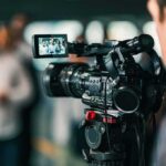 Video camera filming a group of people