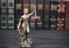 Trump Probe Twist: Brennan In The Hot Seat Lady Justice statue with scales in front of law books