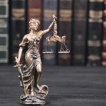 Trump Probe Twist: Brennan In The Hot Seat Lady Justice statue with scales in front of law books