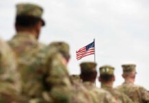 Commanders Gambled – Troops Paid U.S. flag flying above a formation of soldiers in uniform