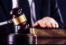 Dormant Terror Court Awakens – First Ever Judge's gavel striking block with hand on book in background