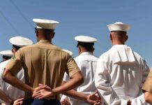 sailors and marines standing in formation with hands behind backs