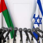 UAE and Israel flags behind microphones