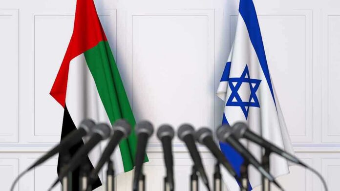 shutterstock_1254441925 UAE and Israel flags behind microphones