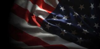 United States flag with stars and stripes in dramatic lighting