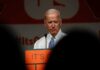 Gas Guzzlers Back? Biden’s EV Mandate OUT older man at a podium speaking on stage