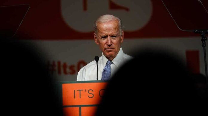older man at a podium speaking on stage