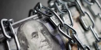 US dollar bills wrapped in metal chains