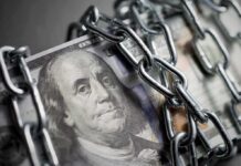 US dollar bills wrapped in metal chains