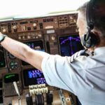 Booze Allegation – Wild Misrata Crash Sparks Pilot Detention Pilot adjusting controls in an airplane cockpit