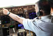 Booze Allegation – Wild Misrata Crash Sparks Pilot Detention Pilot adjusting controls in an airplane cockpit