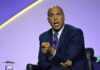 Booker Explodes: Trump ‘Criminal’ Warning Cory Booker speaking on stage in a suit and tie