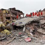 Xi Orders ‘Scientific’ Probe—Casualties Go Fuzzy Rescue workers in orange uniforms on a collapsed building site after an earthquake