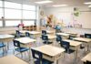 Cat-in-the-Hat Panic Closes Schools Empty classroom with rows of student desks and chairs