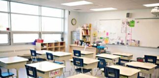 Empty classroom with rows of student desks and chairs