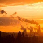 Grid Twist In India – Coal Loses Ground Power plant cooling towers emit smoke at sunset