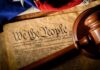 U.S. Constitution with gavel and flag