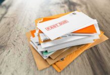 Stack of mail with past due notice on top