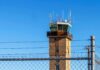 LaGuardia Shock: Time-Card Fraud Tied To Deadly Collision Airport control tower behind chain-link and barbed-wire fence