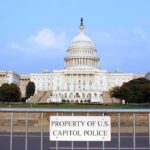 Congressional Cover-Up Culture View of the U.S. Capitol building with a security barrier in front