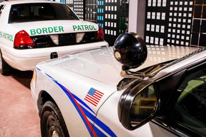 shutterstock_1949329927 Police patrol cars parked indoors with cityscape backdrop